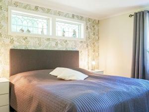 a bedroom with a bed with a blue blanket at 6 person holiday home in LYSEKIL-By Traum in Lysekil