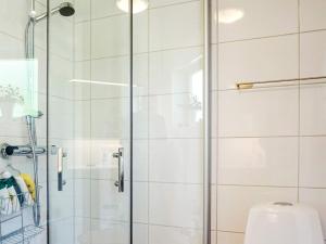 a shower with a glass door in a bathroom at 6 person holiday home in LYSEKIL-By Traum in Lysekil +16 photos