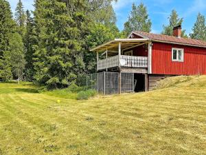 a red house with a balcony on a hill at 4 person holiday home in MOLKOM-By Traum in Molkom
