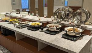 a buffet line with many plates of food on it at Tourist Inn Kochi in Kochi