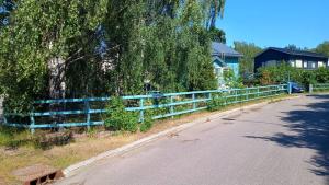 a blue fence on the side of a road at Helsinki Blue House in Helsinki +8 photos
