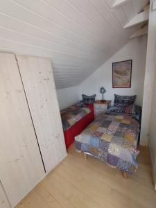 a attic bedroom with two beds and a closet at Helsinki Blue House in Helsinki