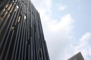 a tall black building with the sky in the background at The Brunei Hotel in Bandar Seri Begawan