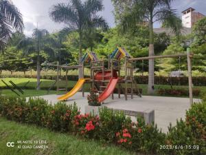 a playground with a slide in a park at Apto Di Sole Santa FeAntioquia in Santa Fe de Antioquia