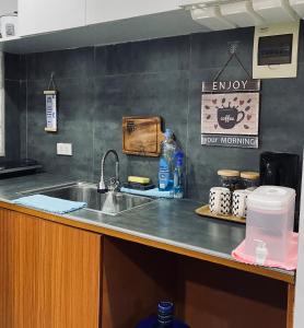a kitchen with a sink and a counter top with a counter at AKC AirBNB in Mandaue City