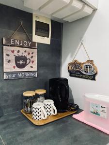 a coffee shop with mugs and signs on the wall at AKC AirBNB in Mandaue City