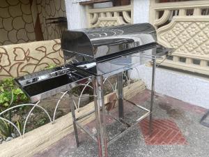 a stove top oven sitting next to a bench at Teo’s Spacious and Affordable Home in Cabanatuan in Cabanatuan