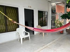 a hammock on the porch of a house at Casa Encanto Cartagena Colombia in Cartagena de Indias