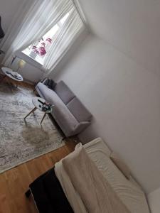 a living room with a couch and a window at Studio in Malmö