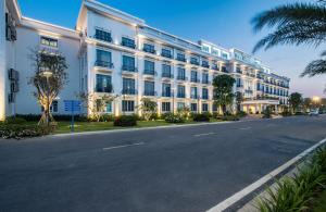 a large white building on the side of a street at The Harmonia in Quang Ngai