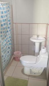 a bathroom with a toilet and a sink at Cabinas Lawson in Puerto Jiménez