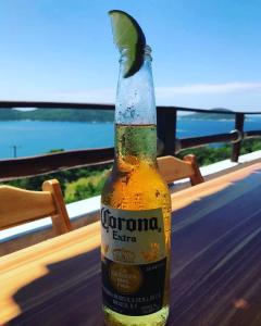 a bottle of corona beer sitting on a table at Pousada Recanto Marinho in Arraial do Cabo
