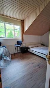 a small room with a bed and a window at Duplex avec vue lac et montagnes in Montreux