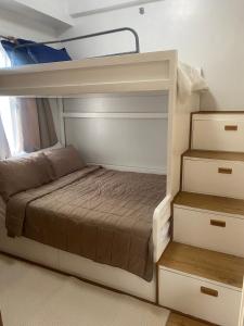 a white bunk bed in a small room at Twenty-Nine Cats - SMDC Cheer Residences Marilao in Marilao