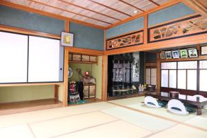 a room with wooden walls and a large window at Farm Stay Ichirobee in Fukui