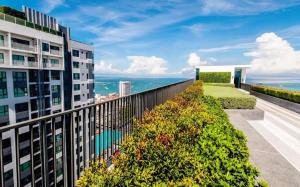 an apartment balcony with a view of the ocean at BASE Central PATTAYA Quiet Room with Infinity Pool & Free Netflix in Pattaya Central