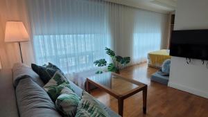 a living room with a couch and a coffee table at Corner Inn in Taichung