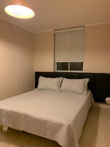 a bedroom with a large bed with a window at vacaciones con laguna in Algarrobo +11 photos