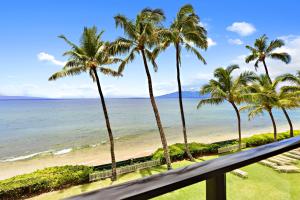 a view of the beach from the balcony of a resort at Mahana 305 in Kahana