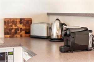 a coffee maker on a counter in a kitchen at Aqua Shores Studio in Mollymook