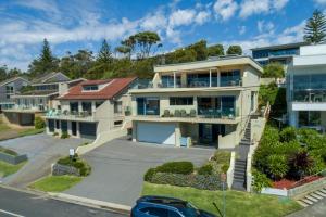 a house with a car parked in front of it at Aqua Shores Studio in Mollymook