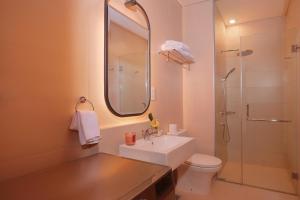 a bathroom with a sink and a toilet and a shower at Citadines Gatot Subroto Jakarta in Jakarta