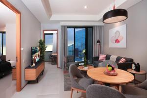 a living room with a couch and a table at Citadines Gatot Subroto Jakarta in Jakarta