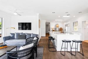 a kitchen and living room with a couch and a table at Woodstock Retreat Milton in Milton