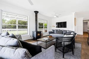 a living room with a couch and a fireplace at Woodstock Retreat Milton in Milton