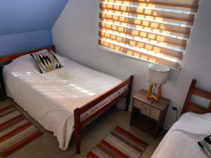 Postel nebo postele na pokoji v ubytování Casa de la Ribera Collipulli