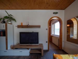 a living room with a flat screen tv on a wall at Kiara Apartments & Rooms in Jesenice