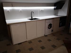 a kitchen with a sink and a washing machine at Black Sea Pearl in Chernomorets +51 photos