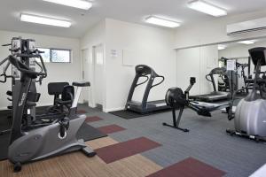 a gym with treadmills and elliptical machines at Beachfront Choices - Beach, Lagoon, Spa ZE1 in Alexandra Headland