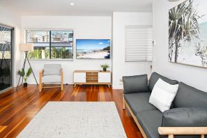 a living room with a couch and a table at Spacious New 2 bedroom Kings Beach Townhouse ZF2 in Caloundra