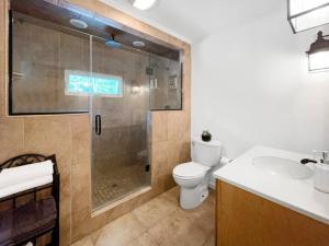 a bathroom with a shower and a toilet and a sink at Haven Retreat in Catskills w Hot Tub & Bar Hall in Sundown +34 photos