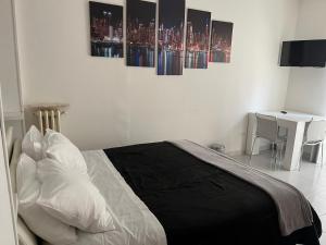 una camera da letto con un letto con quattro dipinti sul muro di D&V MAISON a Potenza