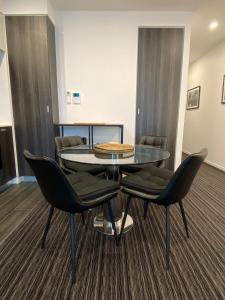 a conference room with a glass table and chairs at Modern, Quiet 1 Bed Apt on Fitzroy St, Opposite Albert Park in Melbourne