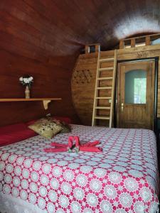 Un dormitorio con una cama con una cinta rosa. en Agriturismo Rossolampone en Gerano