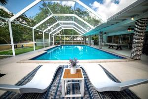 a swimming pool in a building with a glass ceiling at Luxury Miami Village w/Pool+Grill+MiniGolf in Miami