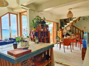 a kitchen with a table and a dining room at Sea Me in Kansaloay