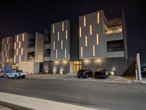 un edificio con coches estacionados en un estacionamiento por la noche en Ain Arees en Medina