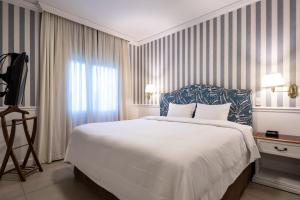 Rúm í herbergi á Hotel Villa Morra Suites