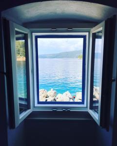 a window in a room with a view of the water at Valun 61 in Valun