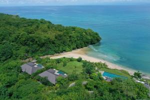 an aerial view of a beach with a house and the ocean at Raffles Bali in Jimbaran