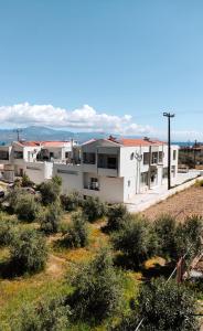 a row of white buildings on top of a hill at Tasos Art in Kato Almiri