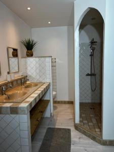 a bathroom with two sinks and a shower at La Cité Secrète in Carcassonne +56 photos
