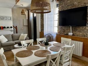 a dining room with a white table and chairs at La Cité Secrète in Carcassonne