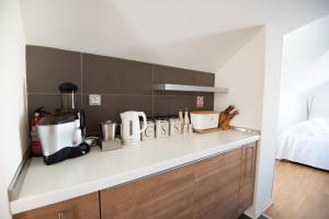 a kitchen with a counter top with appliances on it at Milic Apartments - by the sea in Sutivan