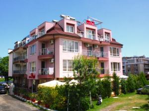 a pink building with a sign on top of it at Hotel Paradise in Lozenets