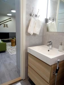 a bathroom with a sink and a mirror at Hotel Hiisi Hill in Jämsä +40 photos